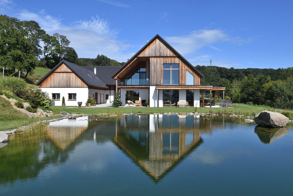 modernes Holzhaus spiegelt sich in einem See